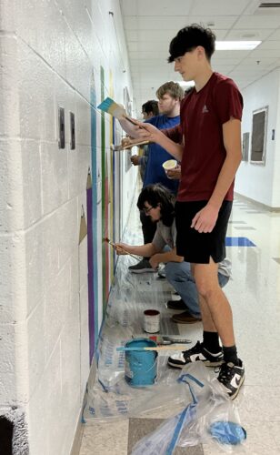 SL art students adding murals to elementary